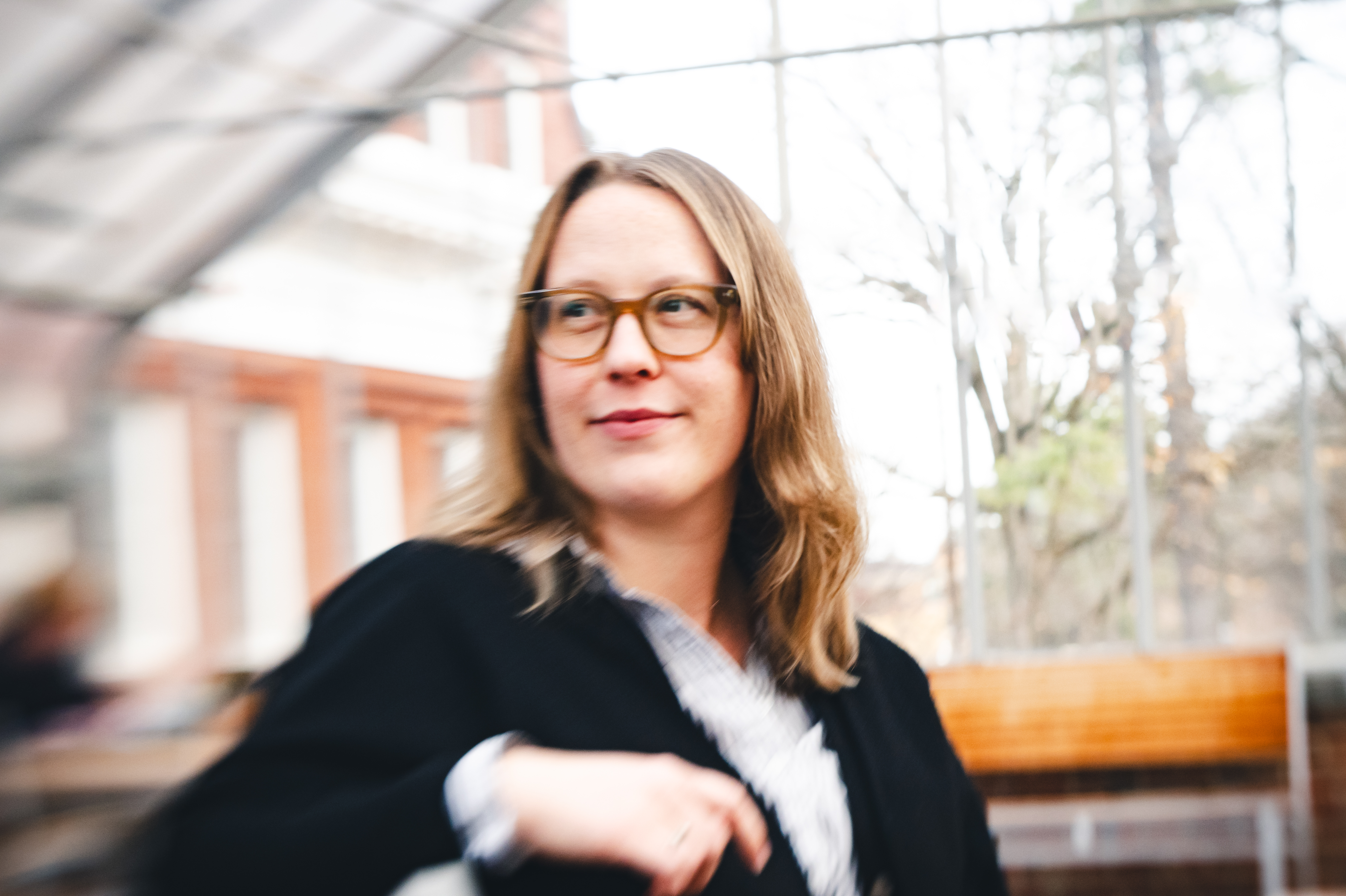A photo of Amy. She is a white woman with dark blond hair wearing glasses and a black sweater.
